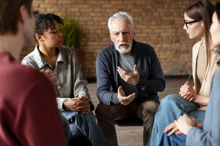 Diverse group of individuals engaged in supportive group therapy session
