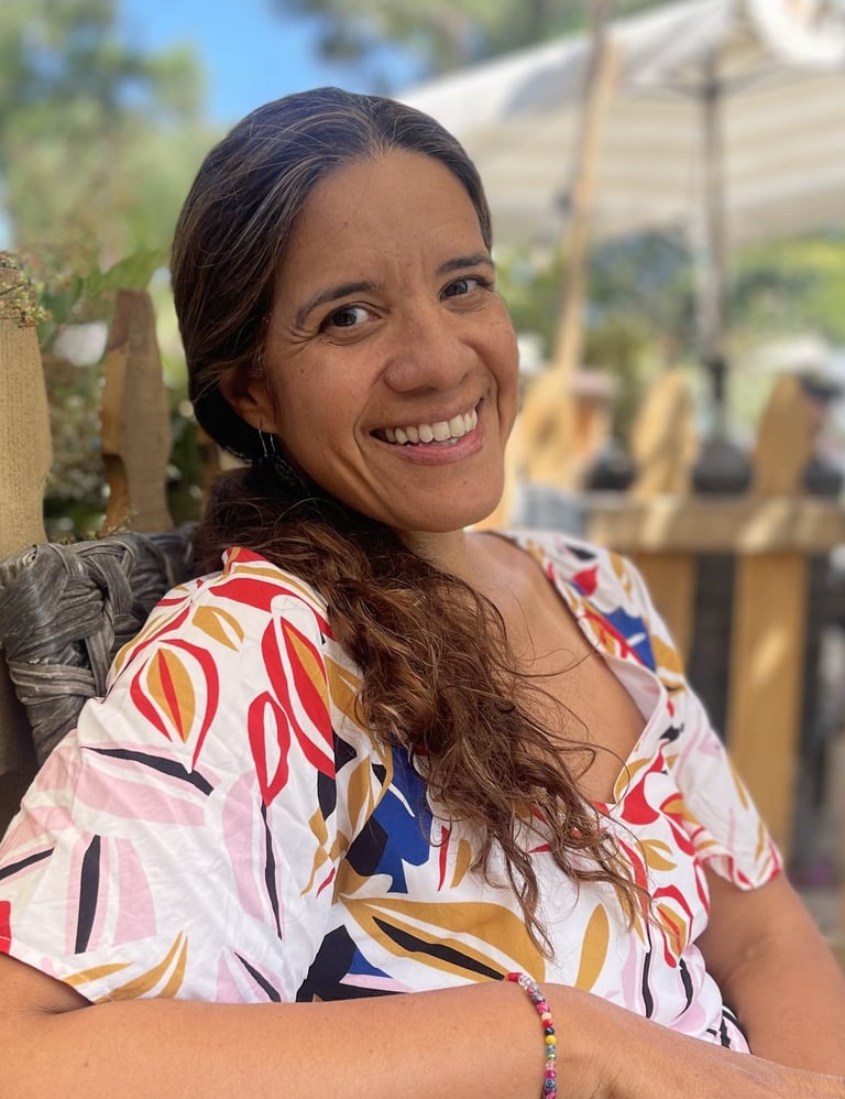 Dr. Camacho Duran smiling in outdoor garden setting